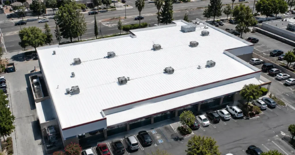Aerial view of a completed acrylic roof coating restoration on a commercial flat roof with rooftop HVAC equipment in Southern California by Method Roofing Group