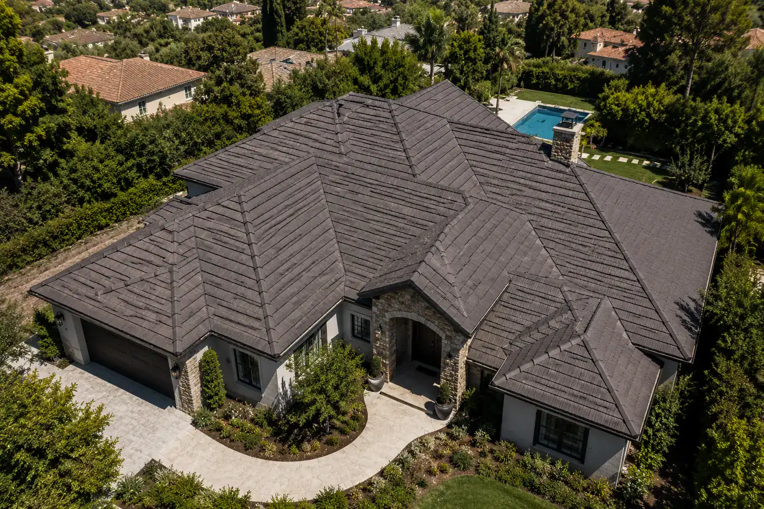expansive charcoal stone-coated steel roof on a luxury Southern California home.