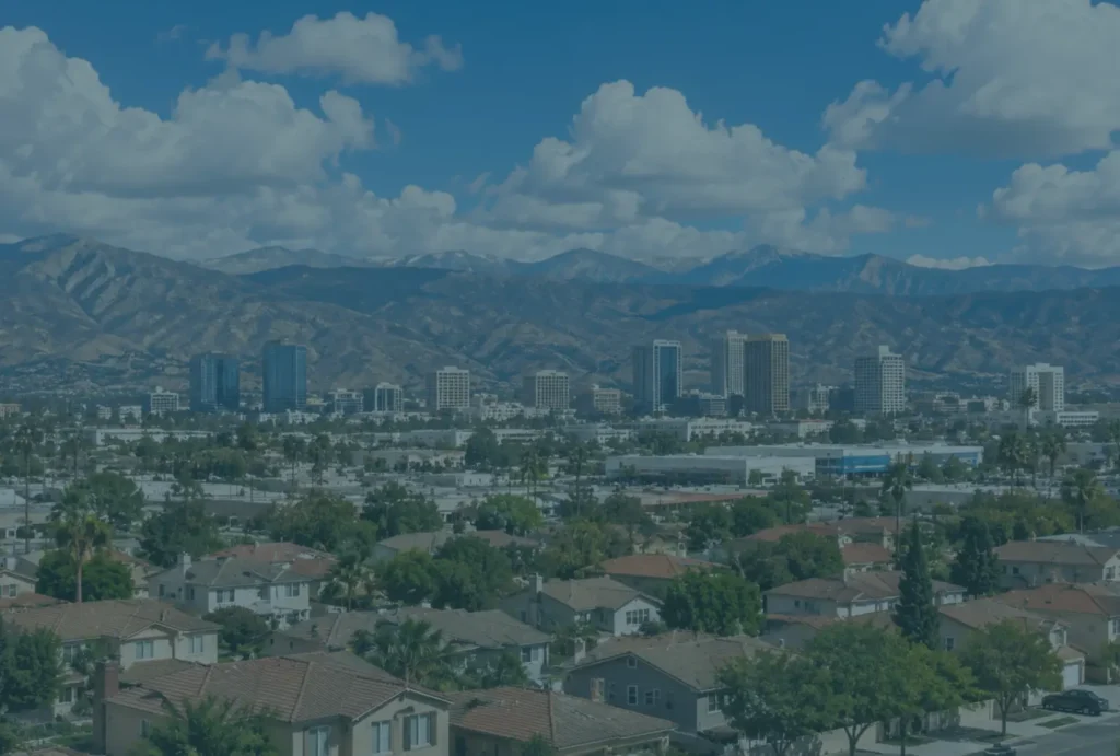 Inland Empire landscape — distribution corridor with mountains backdrop (Ontario / San Bernardino / Riverside aerial), OR a representative IE commercial/residential property image