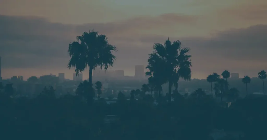Los Angeles County skyline with iconic palm trees representing the geographic service area for Method Roofing Group commercial and residential roofing services