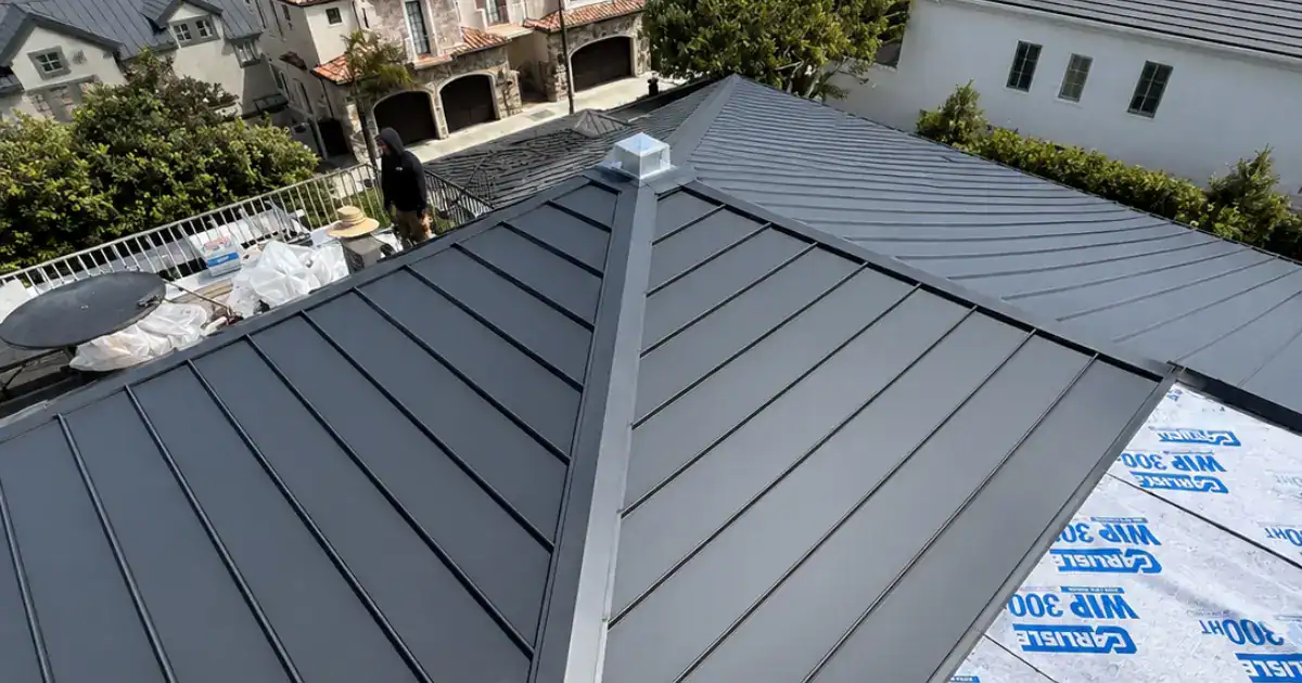Standing seam metal roof installation in progress on a Southern California home, showing installed panels alongside Carlisle WIP 300HT high-temp underlayment.