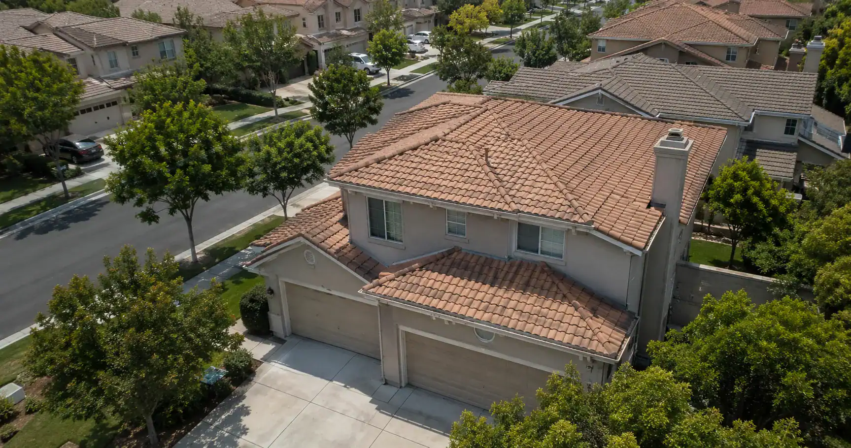 Aerial view of a concrete tile roof on a two-story Southern California tract home — the dominant residential roofing material across master-planned neighborhoods.